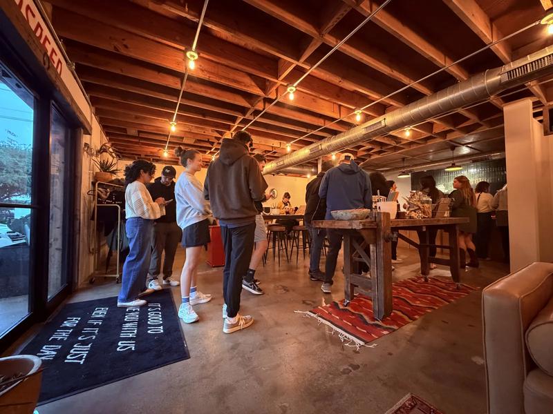 Wide shot of Moon Wolf interior on opening week — lounge, exposed ceiling, crowd at the bar Wide shot of Moon Wolf interior on opening week — lounge, exposed ceiling, crowd at the bar